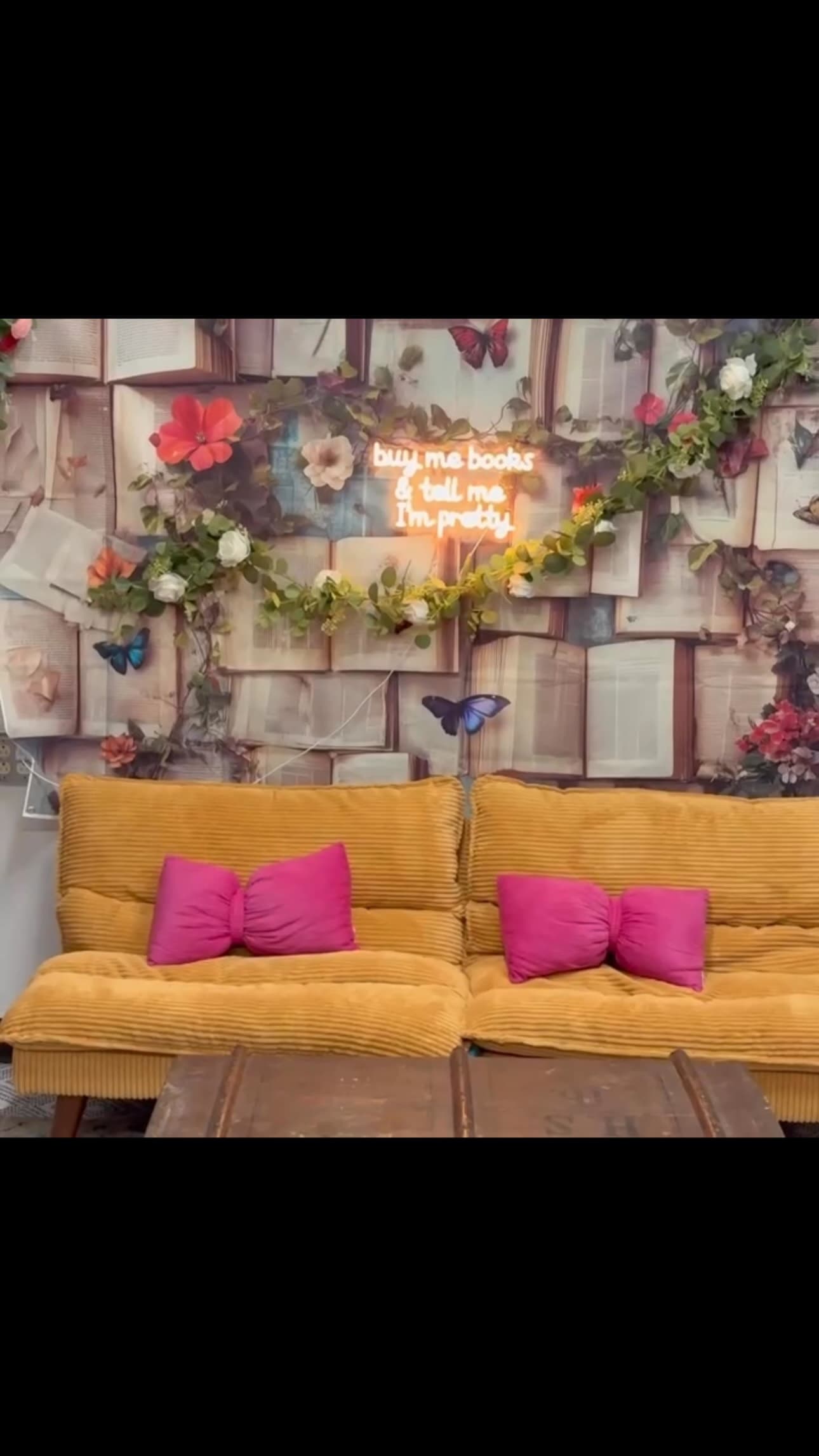 The cozy reading corner at Twists & Tales, two soft couches and a low table between them.