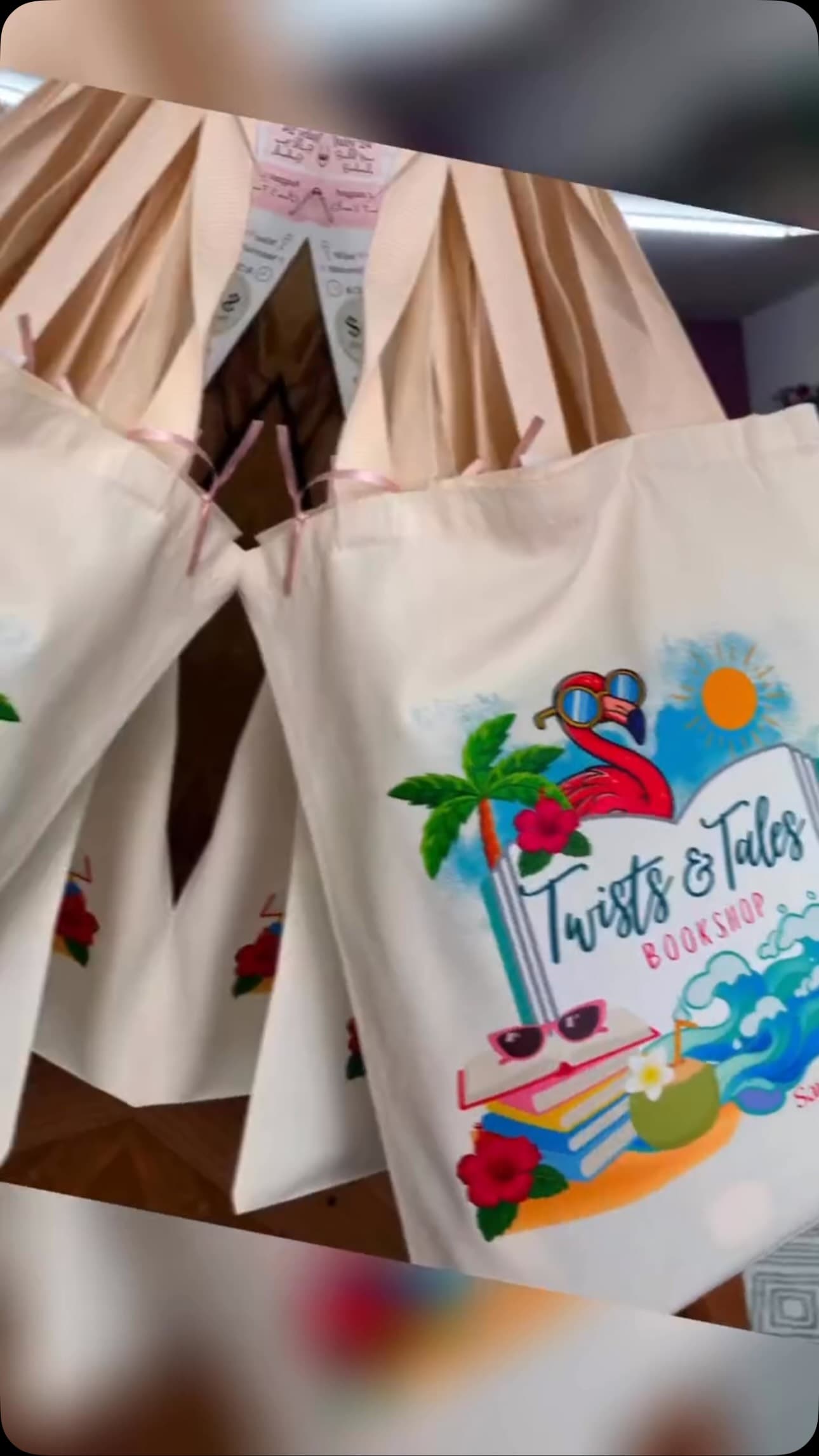 Guests gathered for a Beach Please Book Lotería afternoon at Twists & Tales, tables lined with prizes.