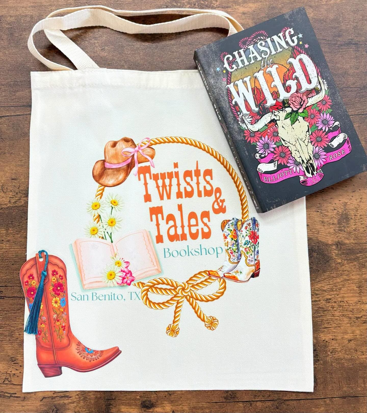 A Book Lotería event tote resting with a cowboy boot and a book, a little South Texas charm.